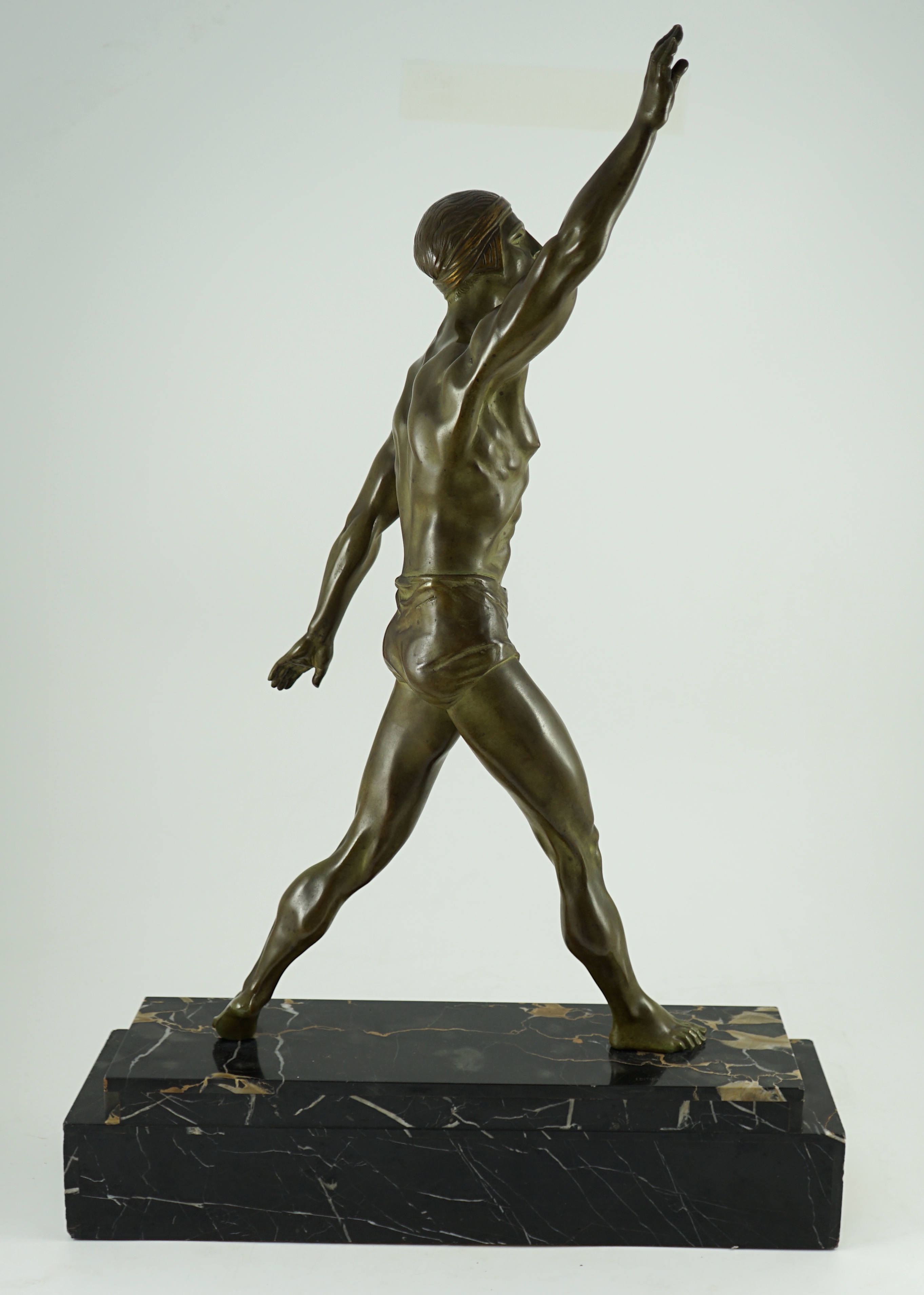 Editions Reverolis of Paris. A 1930's French Art Deco bronze figure of a classical athlete standing with raised arm, width 51cm, depth 15cm, height 76cm